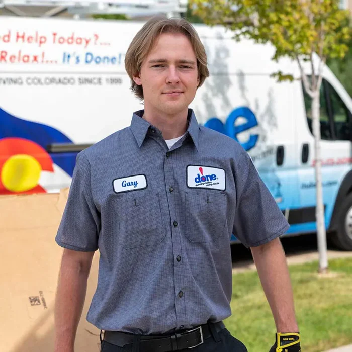 Done technician Gary standing in front of a branded Done service van marked Serving Colorado in an Aurora neighborhood.