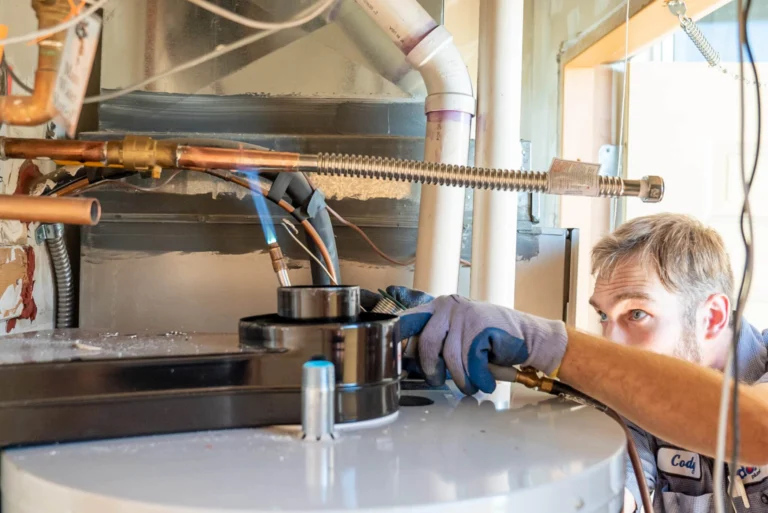 An HVAC technician installing a gas water heater
