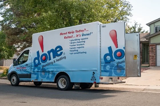A Done truck parked on the street with its doors open