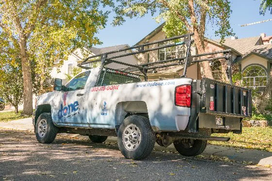 A Done truck parked on a street in a tree-lined neighborhood