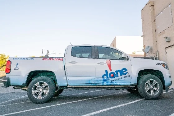 The side view of a Done truck parked on a street