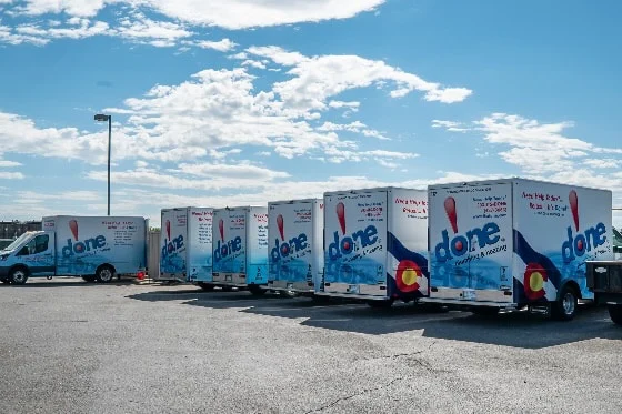 The fleet of Done trucks parked in the lot