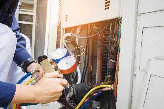 A technician testing the A/C pressure