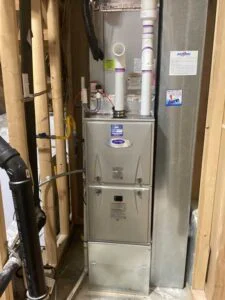 outdoor HVAC unit installed next to home with proper spacing and connections