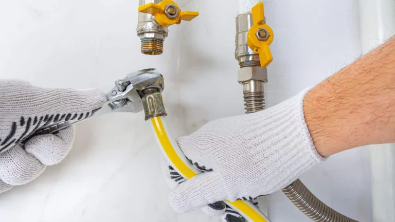 A plumber working on repairing a gas line