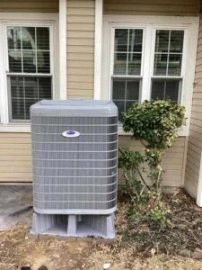 Carrier heat pump installed outside Lakewood home on new equipment pad 