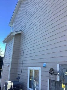 New exterior electrical conduit installed along home siding for HVAC circuit in Castle Rock