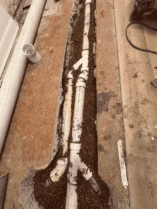 Newly installed sewer line piping in trench inside home Westminster CO