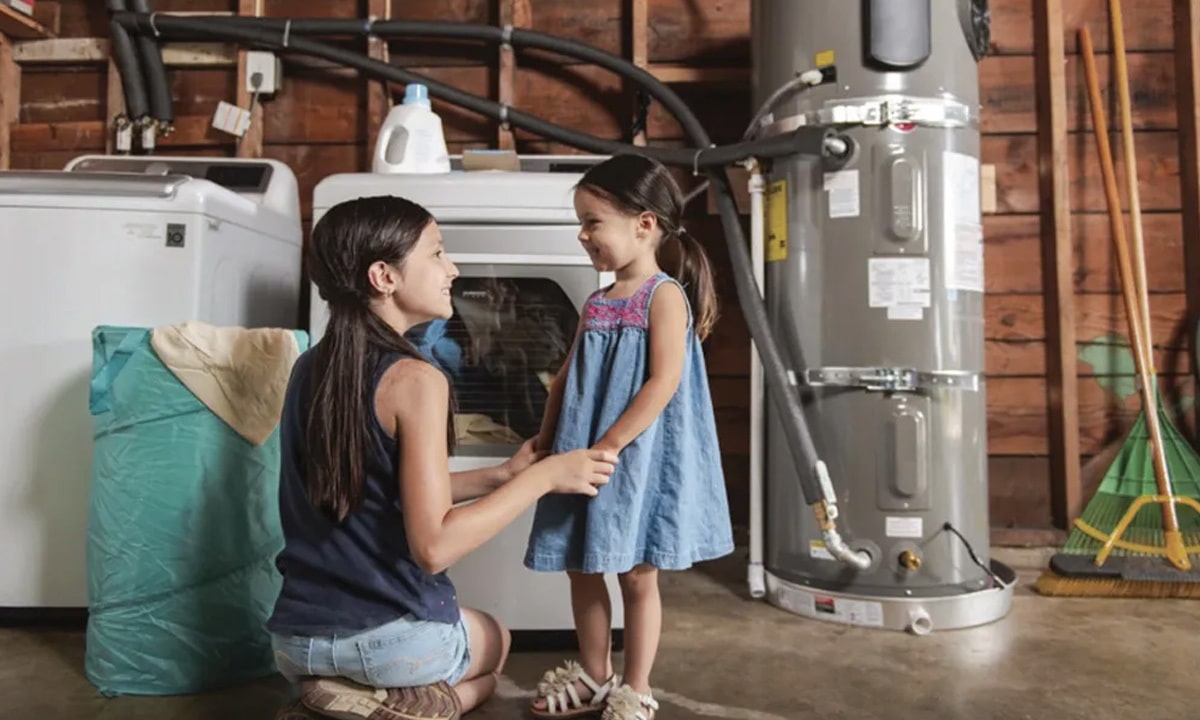 A family standing next to their water heater in the garage