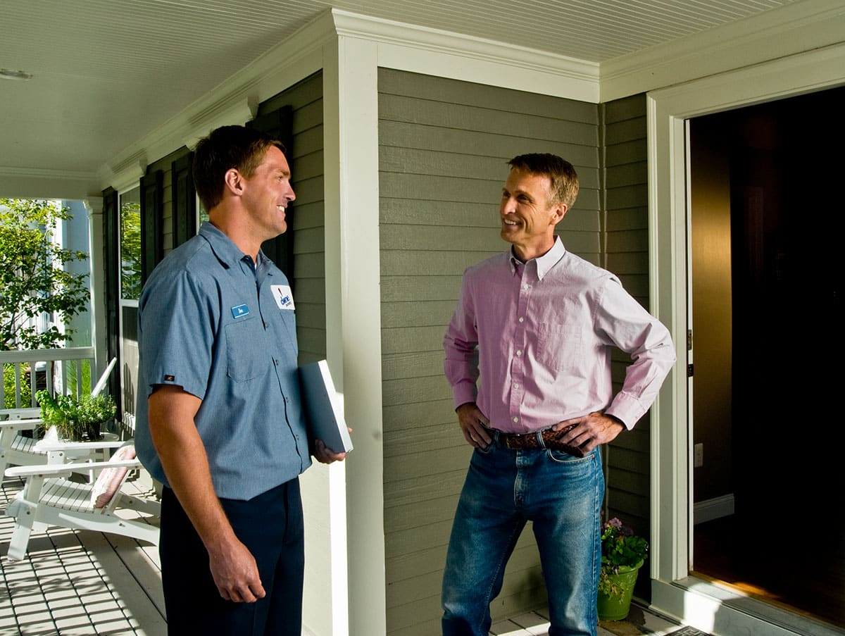 a Done technician and customer talk on a porch