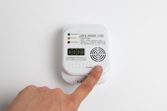 An up-close picture of testing the CO detector in a home