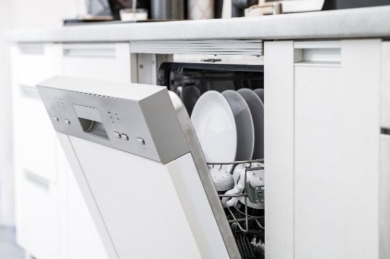 A dishwasher opened with clean dishes