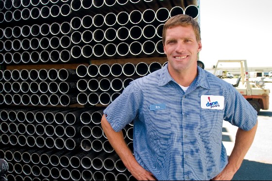 A Done technician standing next to pipes