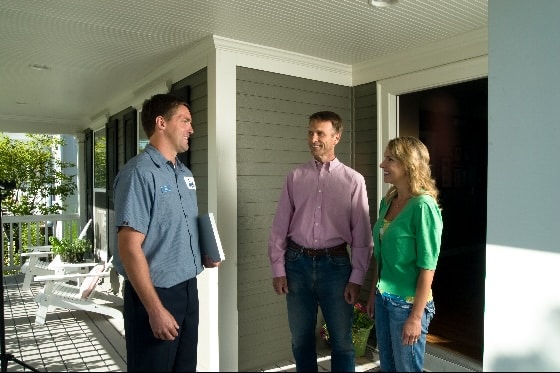 A Done technician and customers talking on the porch