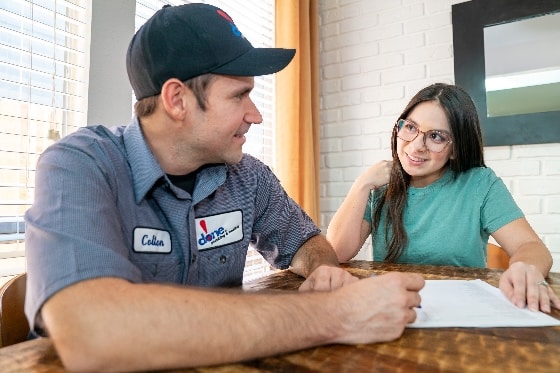 A Done technician reviewing paperwork with a customer at a table
