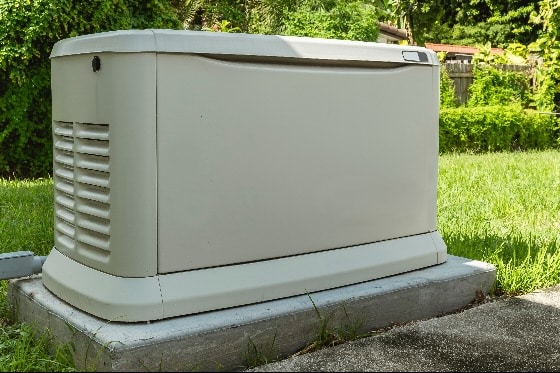 A photo of a home generator installed on a cement pad