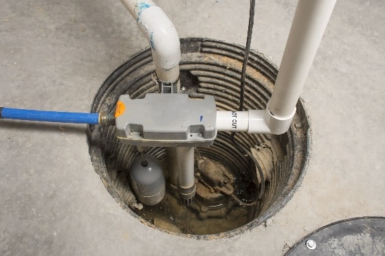 An up-close photo of the sump pump system in the floor
