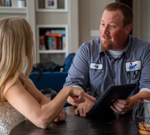 HVAC Tech Reviews Quote With Customer