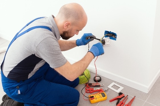 An electrician installing a new outlet