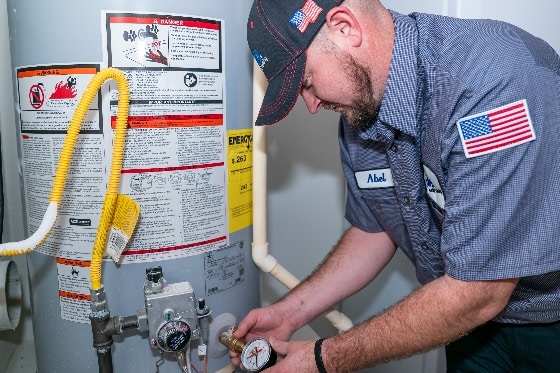 A photo of a Done plumber repairing a water heater