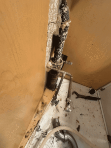 Damaged sewer pipe leaking inside wall at Westminster rental property