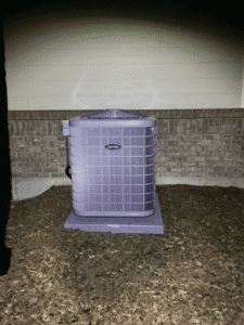 Newly installed air conditioner unit outside home in Castle Rock CO at night