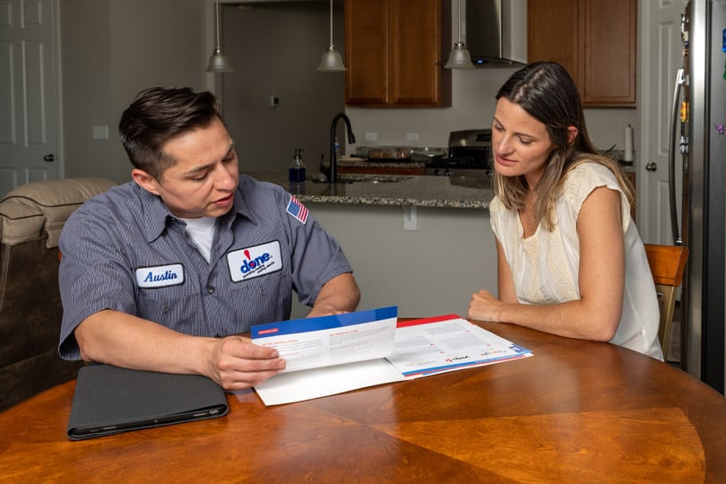 Plumber and homeowner review a project quote