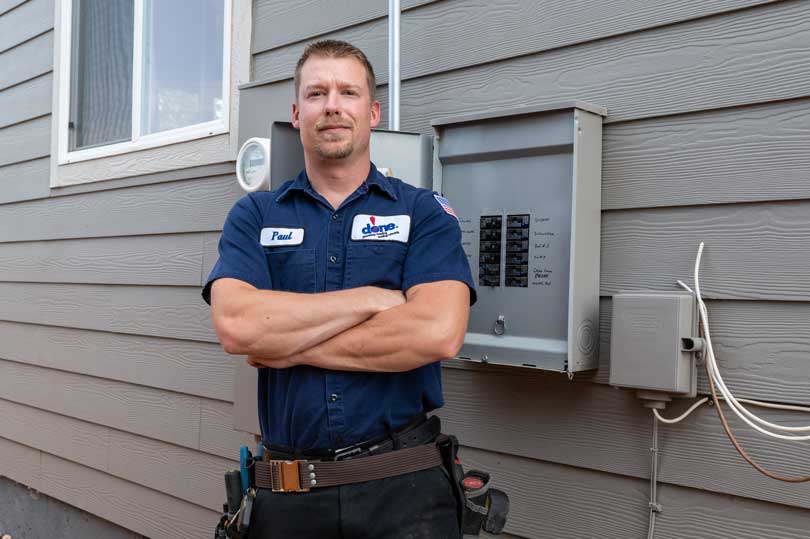 Done! Electrician standing by electrical panel.