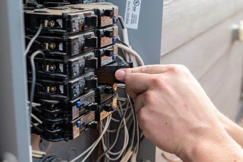 Electrician replaces a circuit in an electrical panel