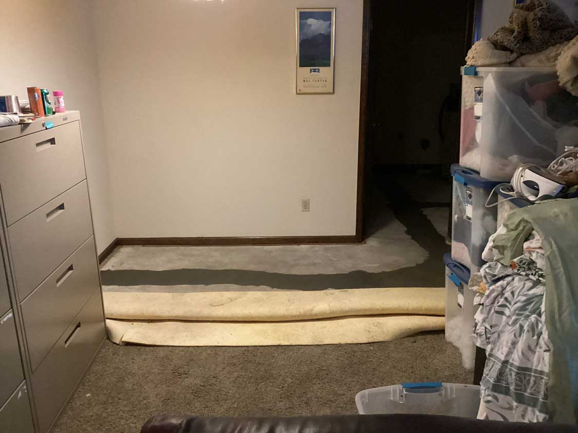 Completed drain line excavation in a Denver home's basement