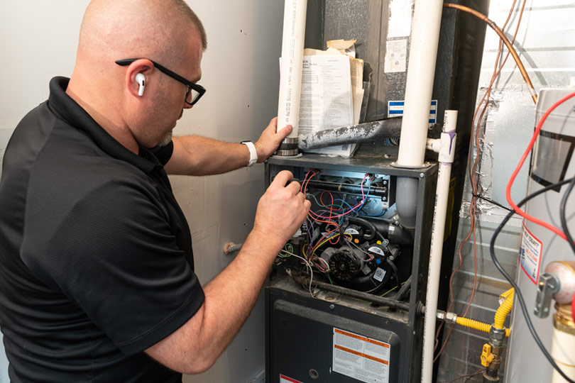 Technician performs a furnace tune-up