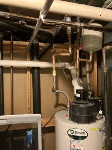 Closeup of the water heater expansion tank, gas lines, and ventilation from a gas water heater installation