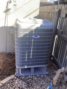Heat pump installation in Denver backyard on leveled pad near home exterior