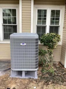 Carrier heat pump installed outside Lakewood home on new equipment pad 