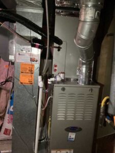 New furnace and air handler system installed with fresh PVC drains and updated ductwork for better airflow and performance.