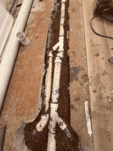 Newly installed sewer line piping in trench inside home Westminster CO