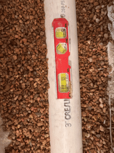 Level tool checking proper slope on new sewer line installation Westminster CO