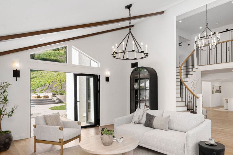 A living room with two candelabra style chandeliers