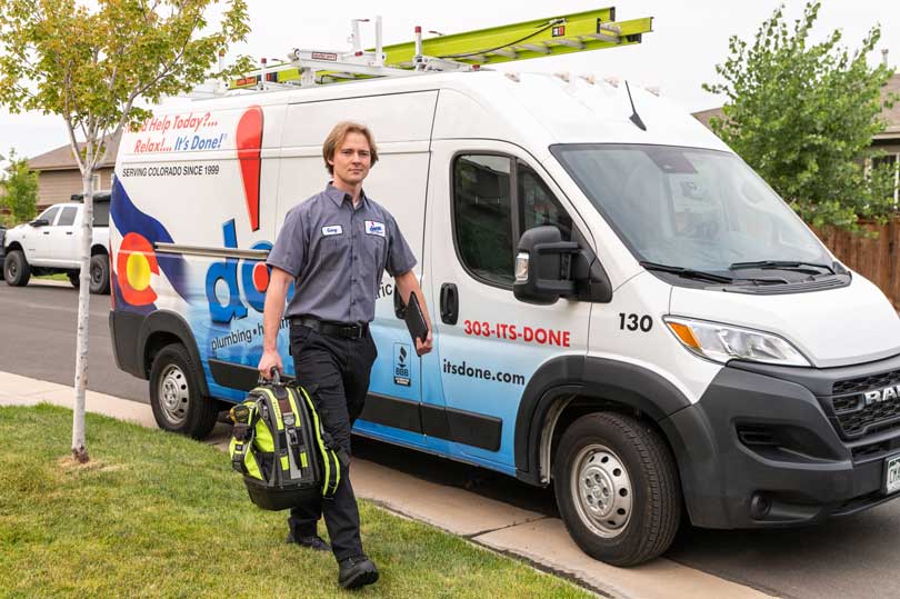 Done! Plumber approaching service vehicle outside.