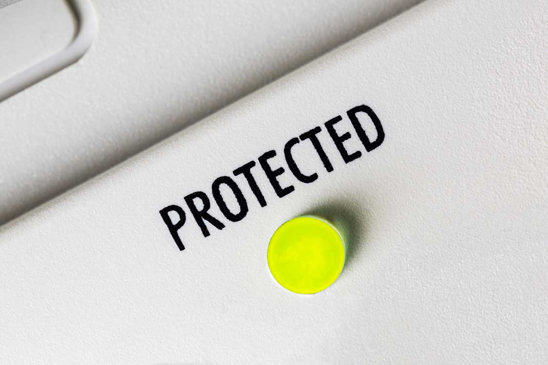 Macro close up photograph of protected indicator light on surge protection power supply device.